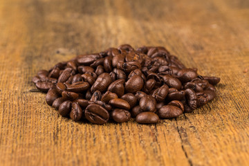 Coffee beans on grunge wooden background