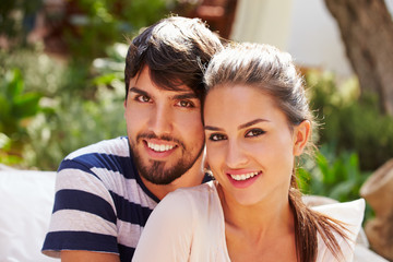 Portrait Of Couple Sitting Outdoors In Garden Together