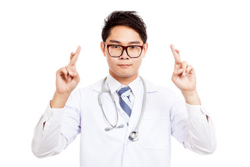 Asian male doctor show double crossed fingers