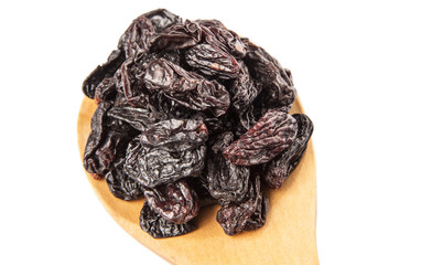 Black raisin on wooden spoon over white background