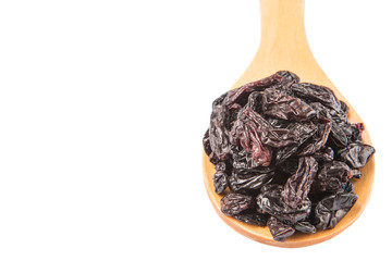 Black raisin on wooden spoon over white background