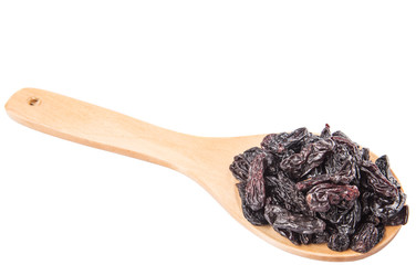 Black raisin on wooden spoon over white background