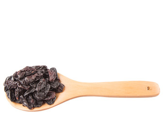 Black raisin on wooden spoon over white background