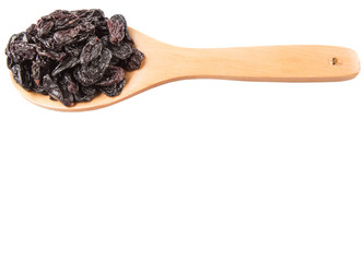 Black raisin on wooden spoon over white background