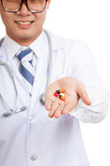 Asian male doctor with pills on his palm hand