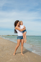 Mother and her daughter  having fun on the beach