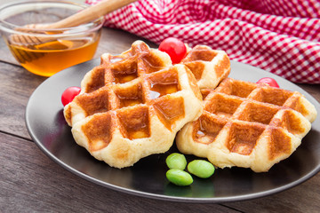 Waffles with honey on plate