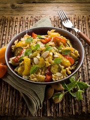 pasta with capsicum zucchinis and sliced almond