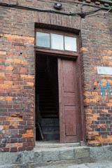 Old wooden door in red brick house