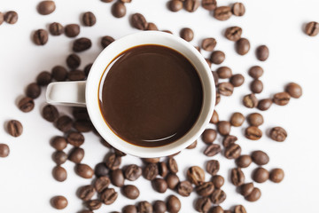 Coffee cup and beans on white