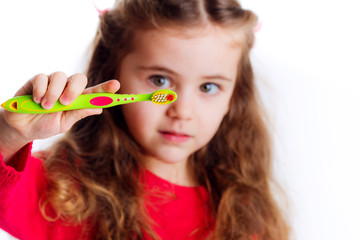 Little girl brushing her teeth isolated on white background