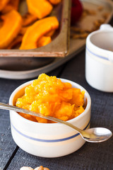 pumpkin puree in a ceramic bowl with spoon, healthy dessert