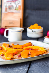baked pumpkin slices with cinnamon and honey on parchment