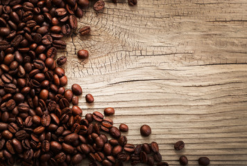 Coffee beans on grunge wooden background