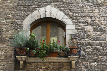 Old wall with a window in a town from Tuscany