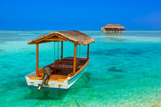 Boat and bungalow on Maldives island