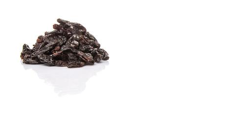 Black raisin over white background