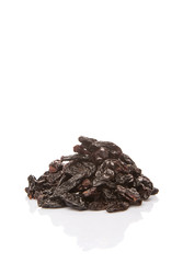 Black raisin over white background