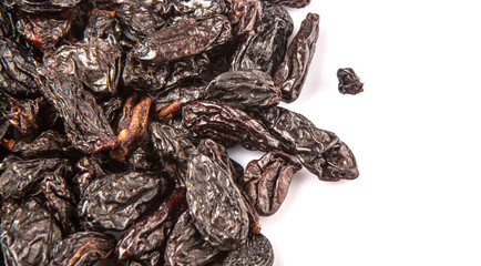 Black raisin over white background