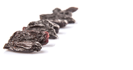 Black raisin over white background 
