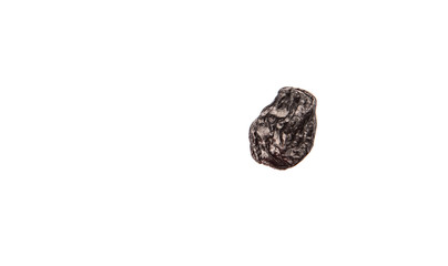 Black raisin over white background 