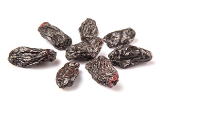 Black raisin over white background 