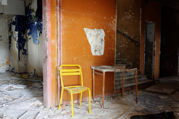 yellow chair and brocken table