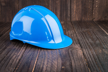 Construction hard hat on wooden background