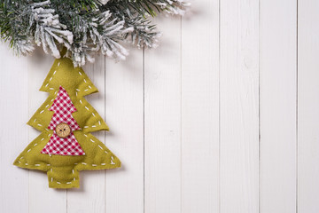 Christmas decoration with fir branches on the background of a tr