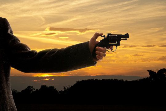 silhoutte of a man with a handgun