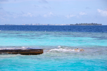 Fototapeta premium Timber pier at ocean Male island view Maldives