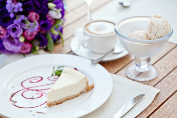 Vanilla cheesecake in restaurant with coffee and ice-cream
