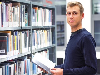 Handsome student in a library