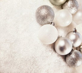 Silver And White Baubles On Snowy Background