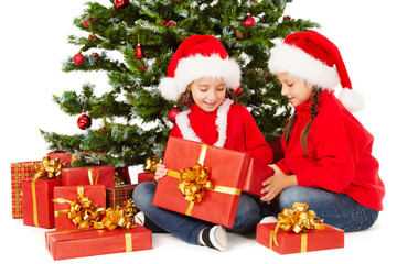 Christmas kids in Santa hat, open present gift box,  xmas tree