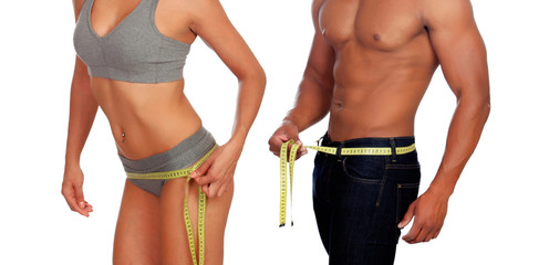 Bodies of man and woman measuring the waist with tape measure