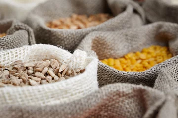 Keuken spatwand met foto Corn kernel seed meal and grains in bags isolated on a wood tabl © ZoomTeam