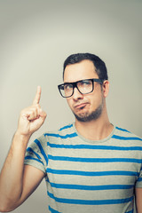 Closeup portrait of young business man pointing up having idea