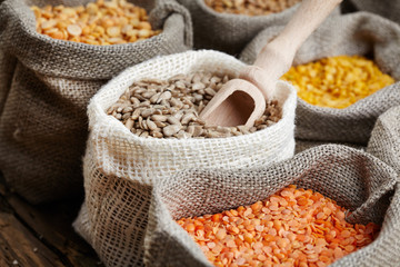 Corn kernel seed meal and grains in bags isolated on a wood tabl