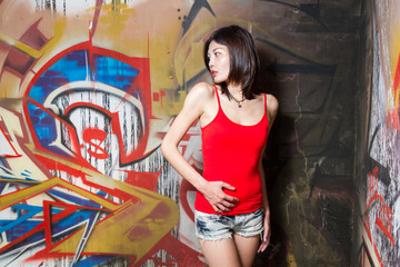 Beautiful Chinese woman by graffiti walls