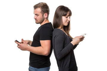 Couple with smart phones back to back