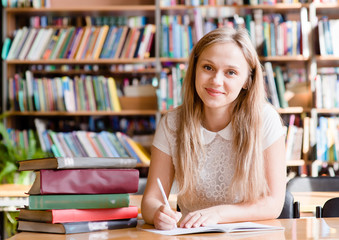 Portrait of a student girl studying at library