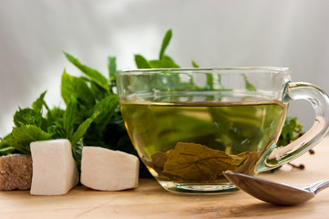 cups of tea with mint on wooden table