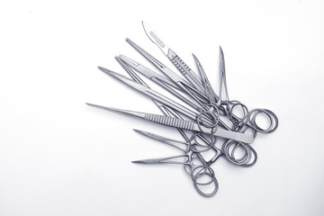 Numerous surgical instruments on a white background