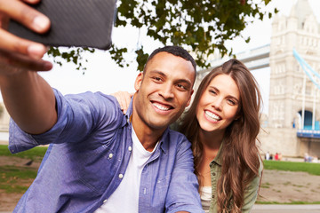 Couple Taking Selfie By Tower Bridge In London