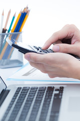 Fototapeta premium Businessman analyzing investment charts with laptop. Accounting