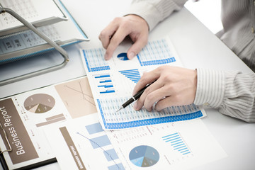 Businessman analyzing investment charts. Accounting