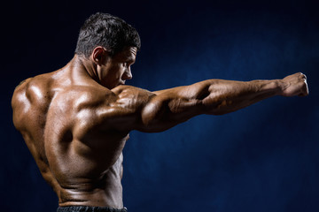 Strong Athletic Man Fitness Model shows the kick