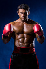 Fototapeta na wymiar Boxer Boxing staring showing strength. Young man looking aggress