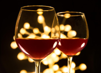 Two red wine glasses. Christmas romantic dinner image.